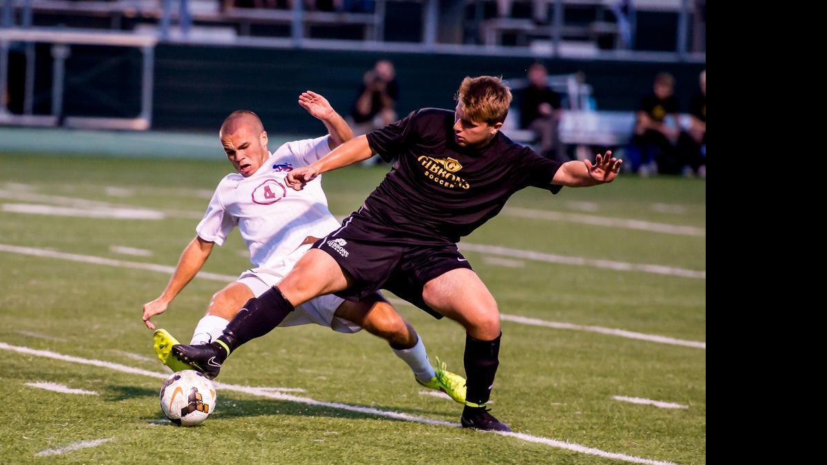 
Cardinal Gibbons defender Alex Paladino (34) keeps the ball from Sanderso’s Alex Strubble (4) on Friday, September 19, 2014. Cardinal Gibbons won 5-0 in the Wake County Cup final.
