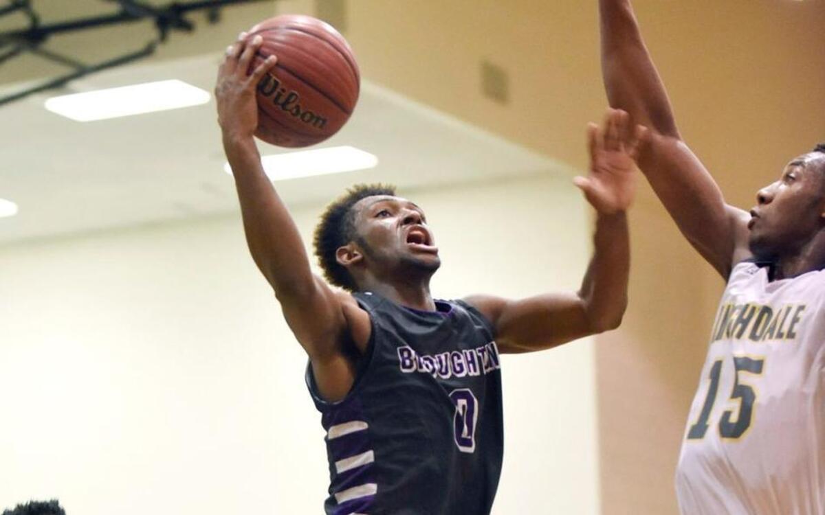 Broughton's Tharon Suggs (0) shoots over Knightdale's Andrew Tuazama (15) in their NCHSAA first-round playoff game in Knightdale, N.C. on Tuesday, February 23, 2016. Broughton won 58-43.