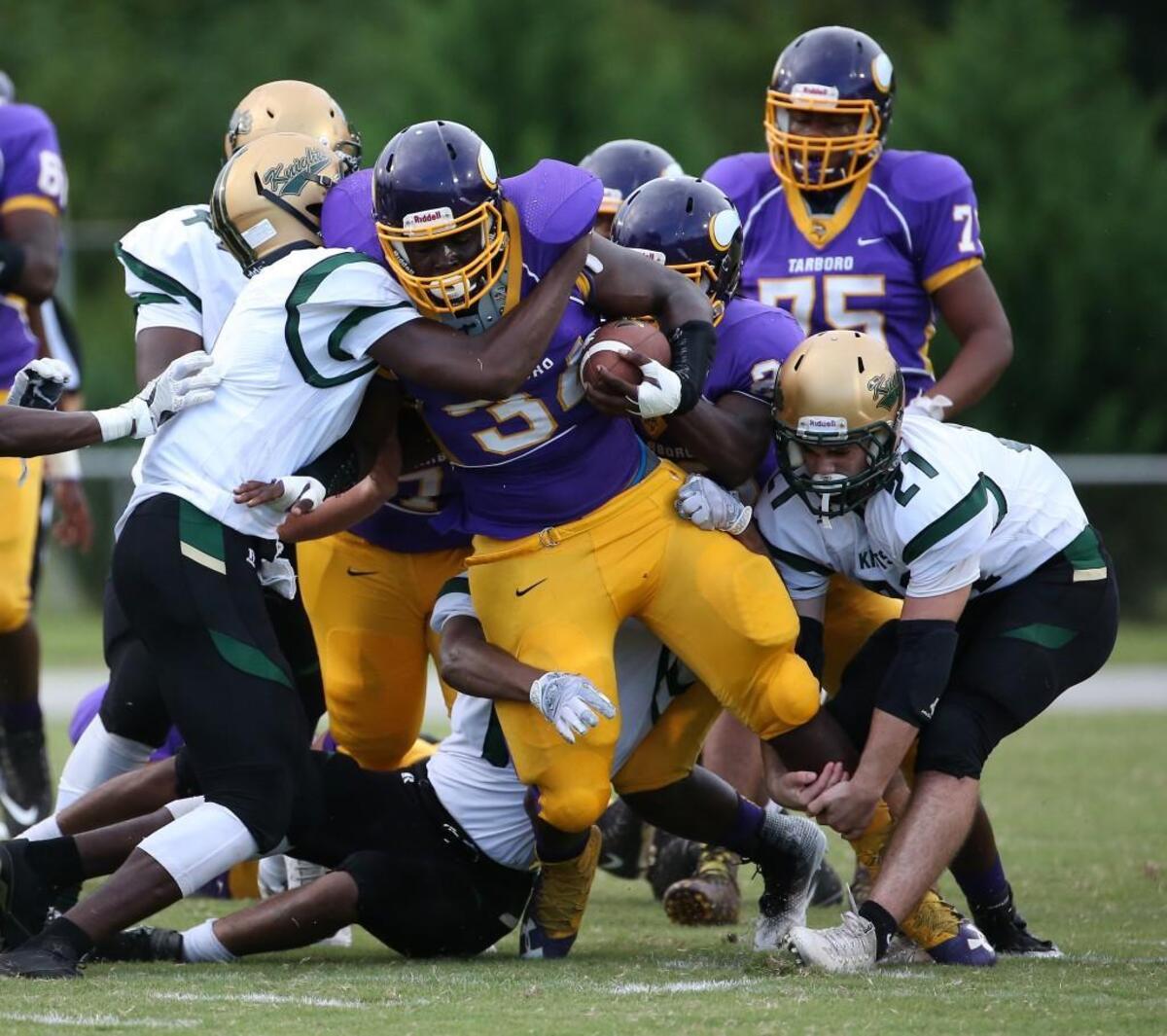 Tarboro's Jaquez Edge drags three Northern Nash players along during the football game with the Tarboro Vikings and the Northern Nash Knights high school in Tarboro N.C. on August 31, 2017.