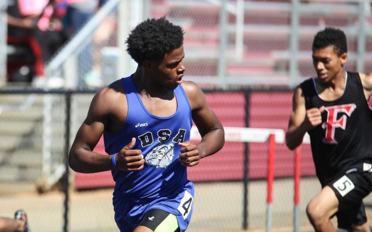 Durham School of the Arts' Wesley Pratt looks back as he approaches the finish line to win the 300-meter hurdles, the even happening immediately after he'd won the 400-meter dash, during the NCC conference championship track meet on Tuesday, May 2, 2017.
