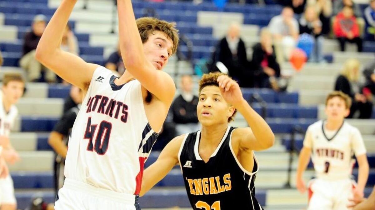 Apex Friendship's Breden Lucero (40) grabs a rebound in front of Fuquay-Varina's Nigel Howell (21) during the boys basketball game, which was played on Tuesday, December 1, 2015 in Apex. Fuquay-Varina won 85-46.