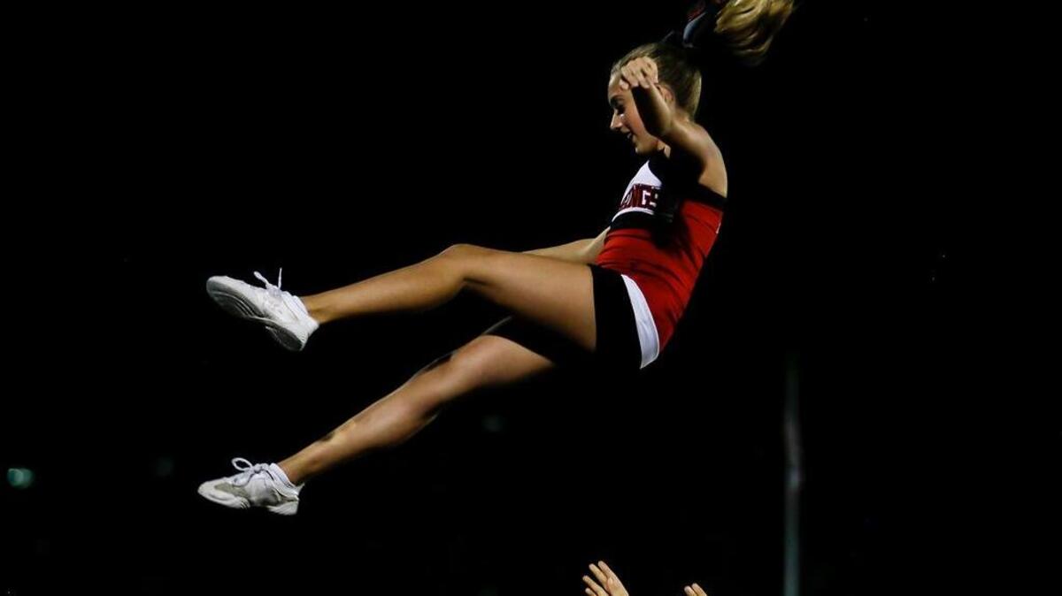 Middle Creek High School cheerleader Morgan Hamilton performs with her team during a time out in Wakefield High’s football game at Middle Creek on Friday, August 19, 2016.