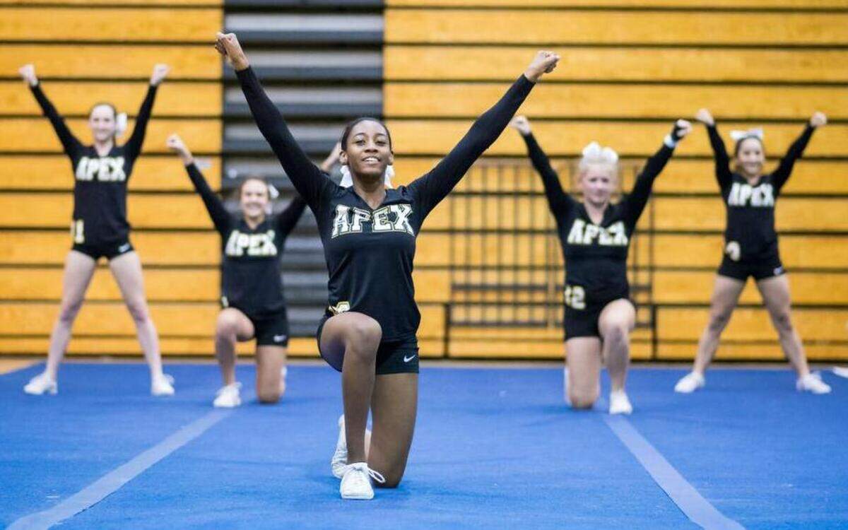 
Apex junior Johanna Gatlin poses at the end of a routine during the double dual Stunt match on Thursday in Cary. 

