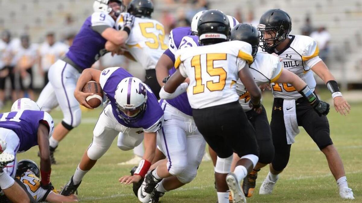 Cole Infinito, second from left, of Riverside breaks through the Tigers' defense to score the first touchdown for the Pirates. The Riverside Pirates played the Chapel Hill Tigers in a football game that took place in Durham, N.C. on Friday, August 19, 2016. Riverside won 35-0.