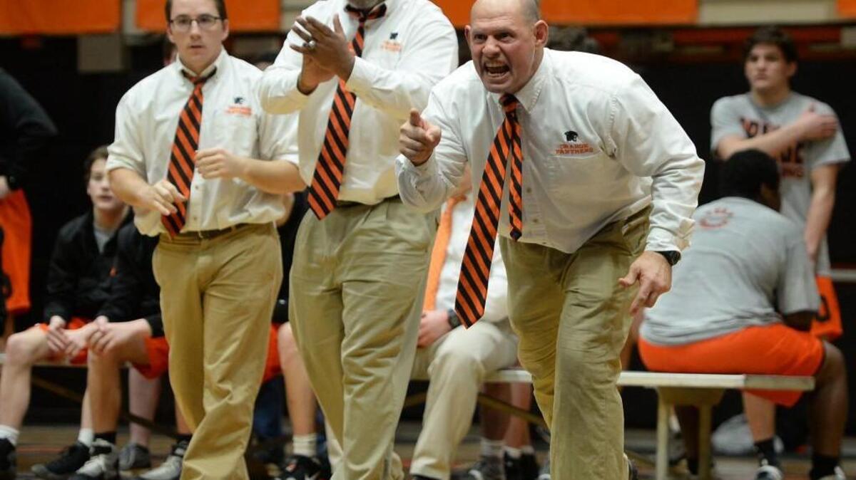 Bobby Shriner, right, head coach of Orange, shouts instructions during the dual team wrestling match between the Orange Panthers and the Chapel Hill Tigers that took place in Hillsborough, N.C. on Thursday, January 26, 2017. Orange won 42-27.