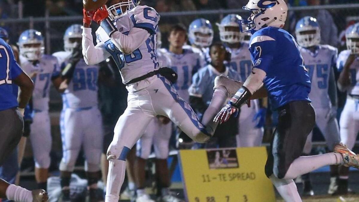 Cleveland's Jon Barnes (80) pulls in a pass from quarterback Darius Ocean as Clayton's Josh Collins (2) prepares to make the tackle. Coverage from the second round of the NCHSAA 3AA football playoffs between the Clayton High Comets and the Cleveland High Rams played in Clayton, N.C. on Friday, November 17, 2017.