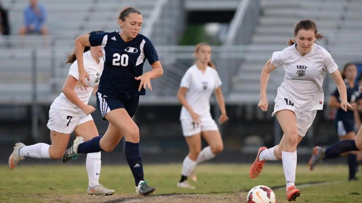 Kylee Brown (20) of Heritage moves the ball against Hunter Pearce (18) of East Chapel Hill. The East Chapel Hill Wildcats played the Heritage Huskies in a girls soccer game that took place in Chapel Hill, N.C. on Tuesday, May 10, 2016. Heritage won 2-0.
