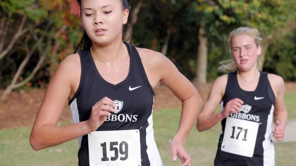 Cardinal Gibbons' Sophie Ebihara (159) leads teammate Annie Pierce (171) the girls race early at the PAC-6 cross country championships, which were held on Friday, October 16, 2015 in Cary.