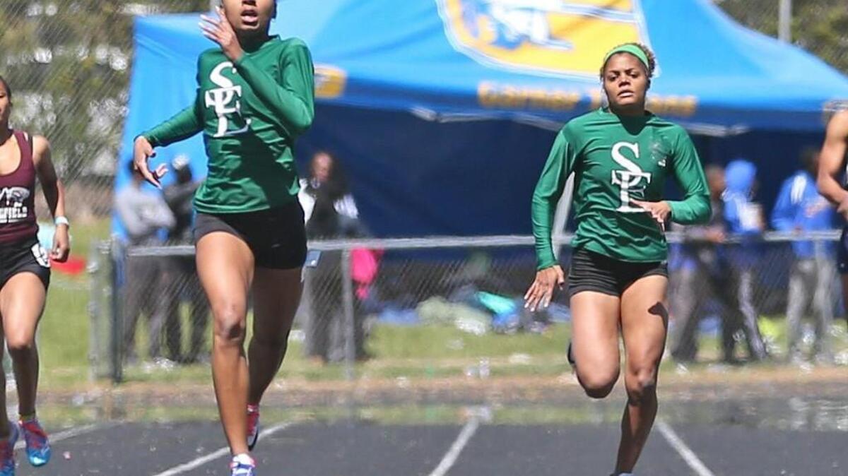 Southeast Raleigh's Kyna Robinson (left) edges out teammate Asya Macon to win the Girls 400 Meter Dash. Coverage from the 2016 Wake County Track and Field Championships held in Garner, N.C. on Saturday, April 9, 2016.