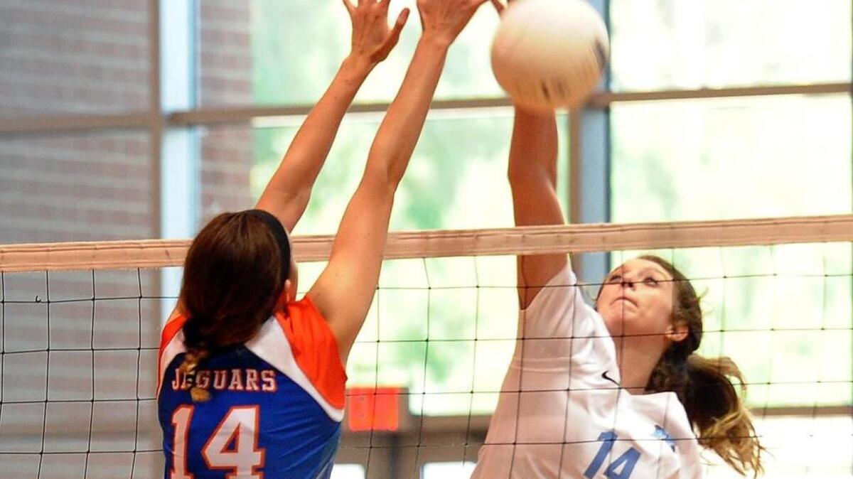 Athens Drive’s Allison Lake (left) and Panther Creek's Caitlyn Della battle at the net during the volleyball game between the Athens Drive Jaguars and the Panther Creek Catamounts in Cary, N.C. on Tuesday, September 1, 2015. Panther Creek won 3-1.