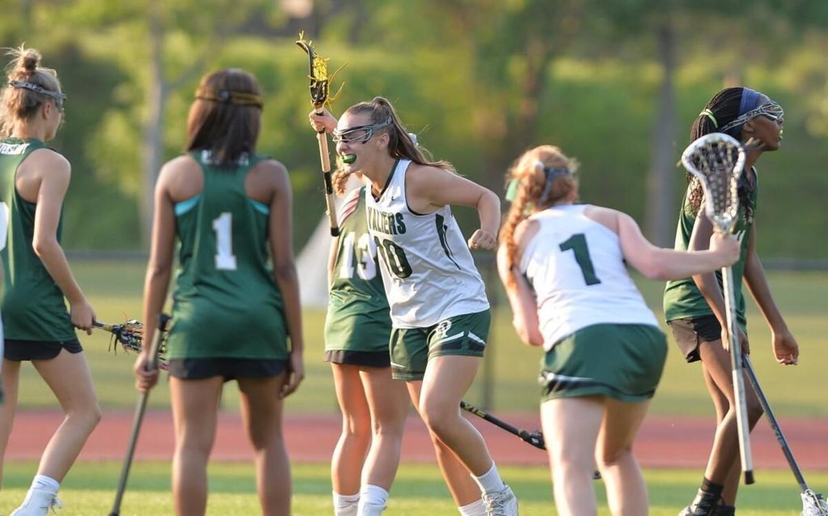 Madison Dunk (10) of Durham Academy celebrates after scoring the winning goal in overtime. The Durham Academy Cavaliers played the Ravenscroft Ravens in a girls lacrosse game that took place in Durham, N.C. on Friday, April 28 2017. Durham Academy won 12-11 in overtime.