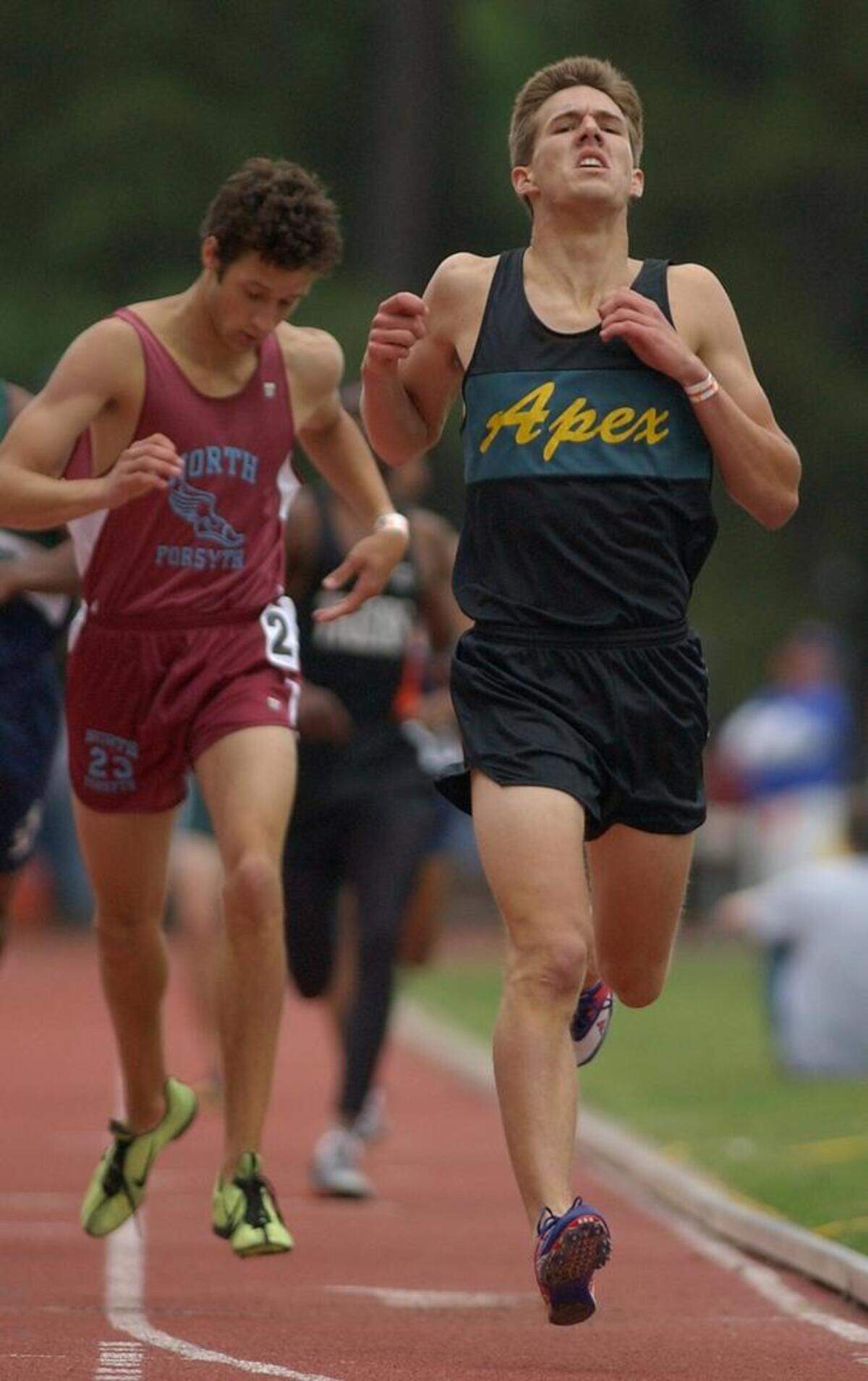 Apex High School's Doug Noreen, right breaths a sigh of relief as he edges out Clay Ragan of North Forsyth High School, left, for the victory in the 800 meter run on May 15, 2003 during the NCHSAA 4A track and field championships.