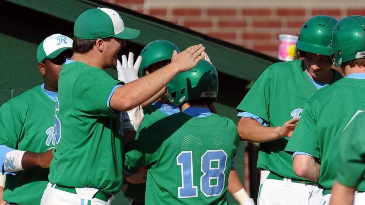 J.H. Rose celebrates a run by Anthony Saieed during the NCHSAA third round baseball game against Cardinal Gibbons, which was played in Raleigh on Saturday, May 14, 2016. J.H. Rose won 5-4.