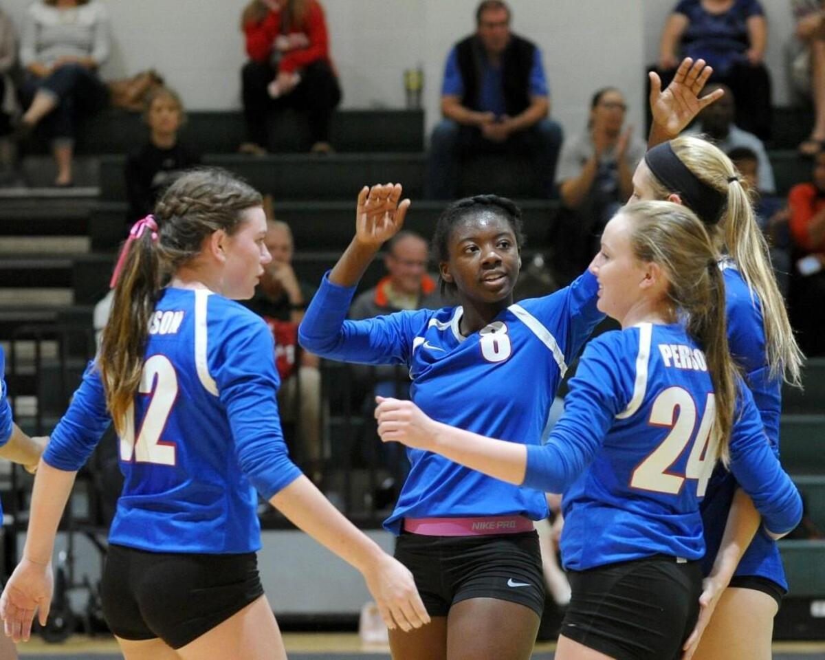 Person celebrates a point during the volleyball match against Cardinal Gibbons, which was played in Raleigh on Tuesday, October 11, 2016.