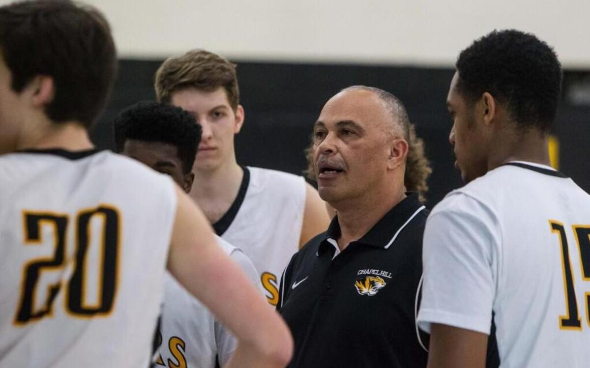 Tiger Head Coach Bill Walton speaks to the team during a time out in a game Jan. 8 against Orange. Chapel Hill finished fourth in the Big-8’s regular season, while Orange finished in second place behind season champion Southern Durham.