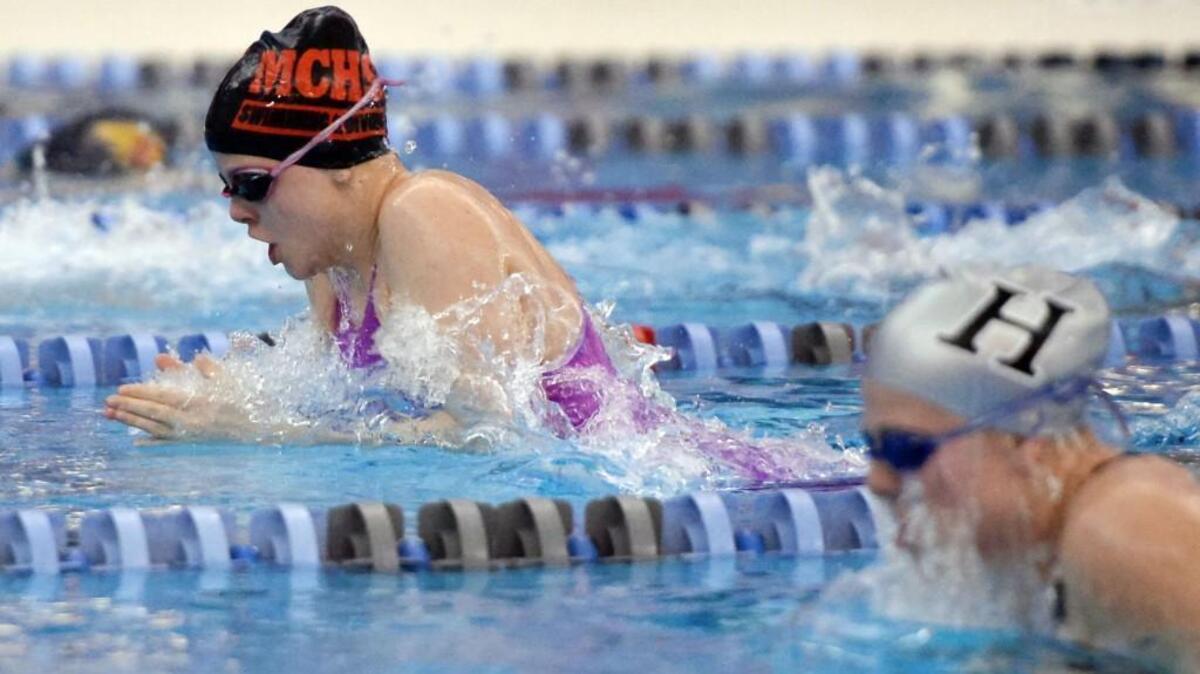 Julia Poole, left, of Middle Creek edges ahead of Margaret Higgs, right, of Hough in the 100m Breaststroke race during the 4A NCHSAA State Swimming Championships that took place at the Triangle Aquatic Center in Cary, N.C. on Thursday, February 11, 2016.