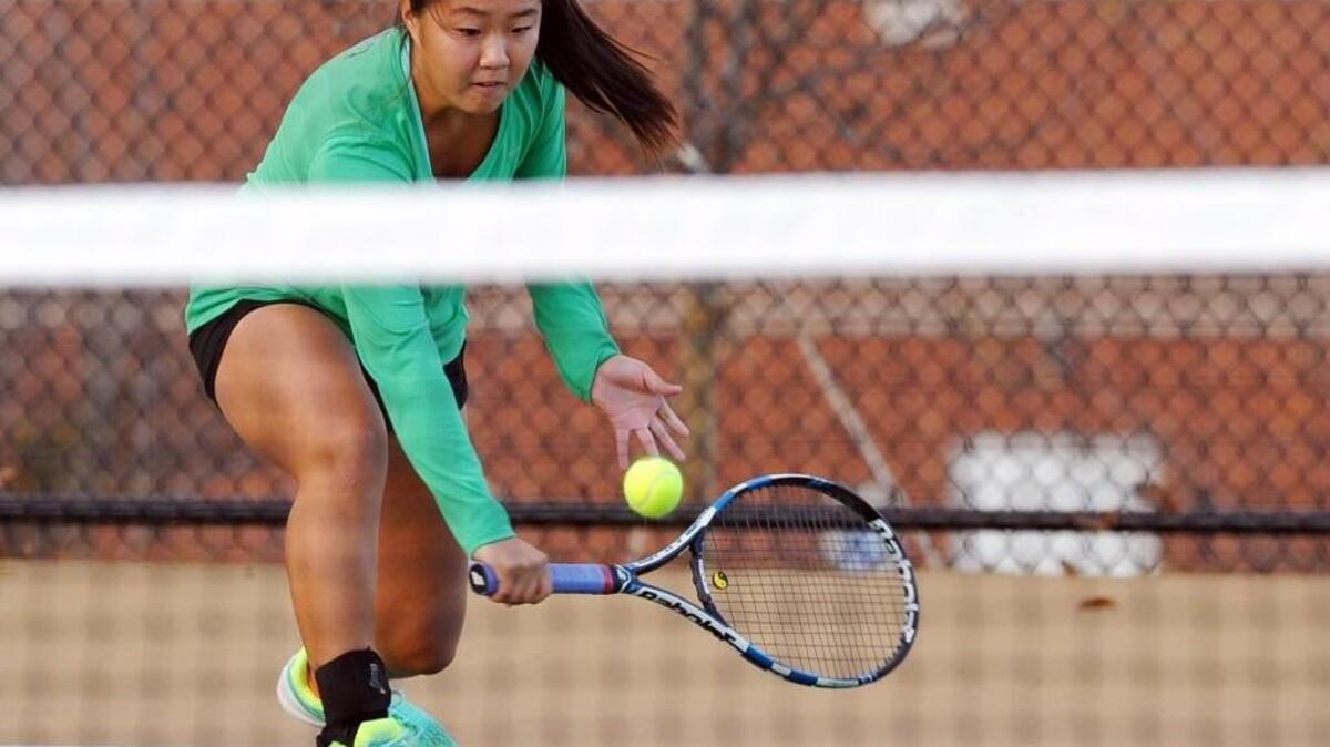 Green Hope's Cynthia Xiao plays at the net during her tennis match against Cardinal Gibbons' Jenna Knors, which was played in Raleigh on Wednesday, November 9, 2016.