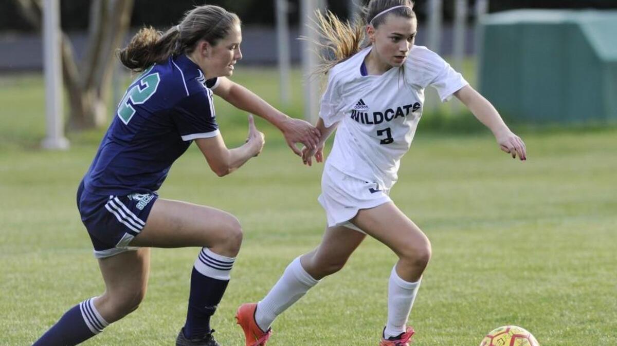 Leesville Road's Madison Hoffmann (22) and Millbrook's Hayley Flowers (3) go after the ball in Raleigh, N.C. on Thursday, April 7, 2016. The game was called because of weather, with the teams tying 0-0.