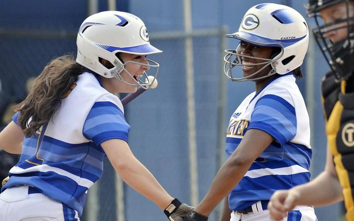 Garner teammates Kristina D’Arco (left) and Kira Jackson celebrate a run scored in their game against Knightdale in Garner, N.C. Thursday, April 21, 2016.
