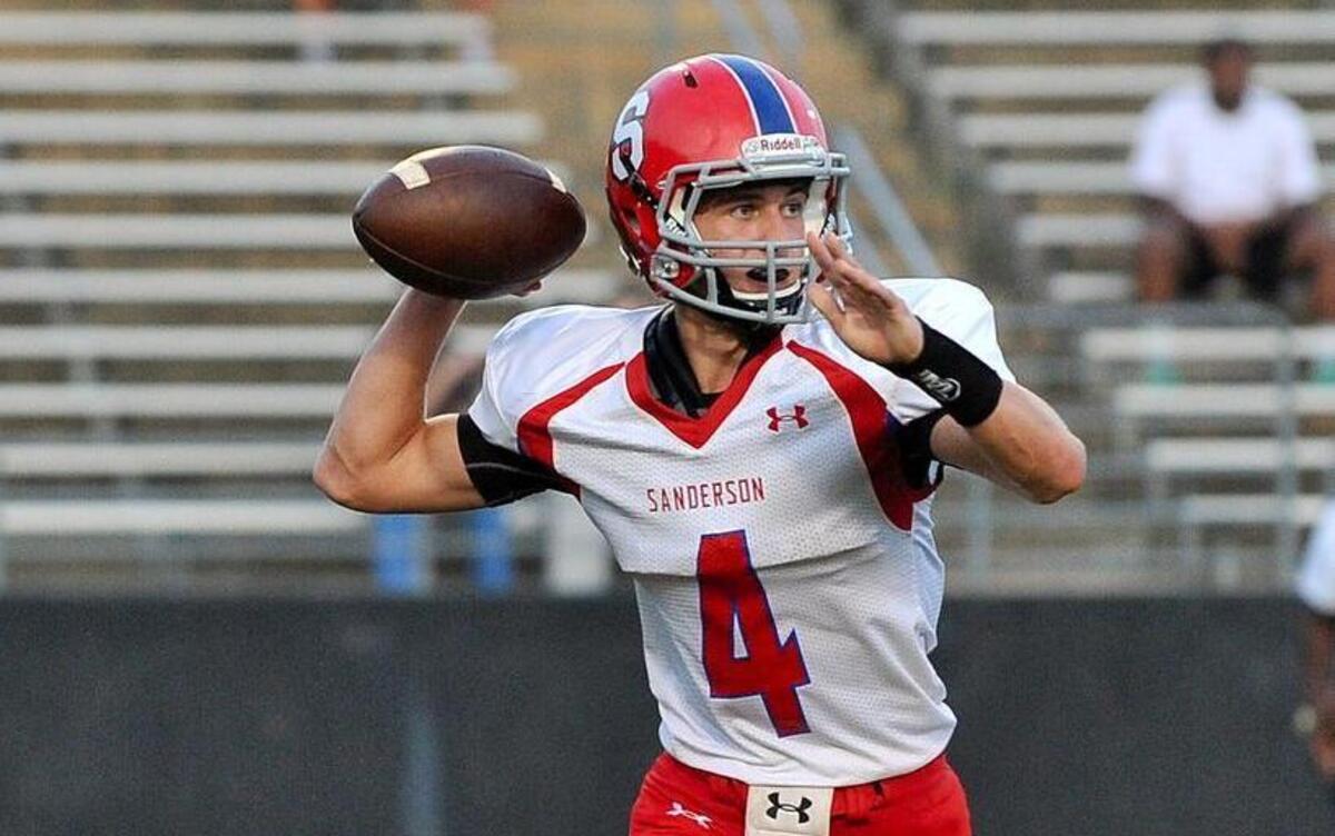 
Sanderson quarterback Brett Bollinger (4) prepares to lauch the pass. Knightdale took on Sanderson in football in Knightdale on Aug. 22, 2014. The graduated passer helped lead the Spartan offense last year. 
