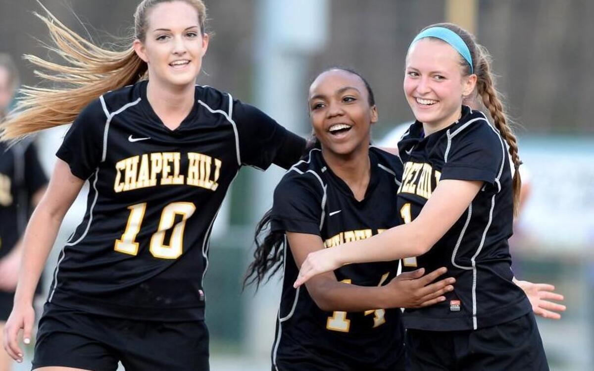 Meg Testen, right, of Chapel Hill celebrates her goal along her teammates, Emily Ball, left, and Lauren Graham during their 2-1 victory over the Carrboro Jaguars on Wednesday, March 16, 2016.