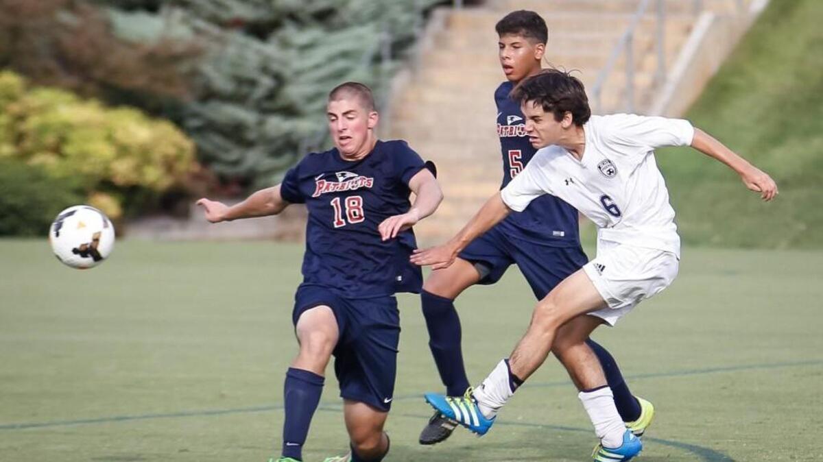Raleigh Charter's Drew DiSerafino (6) fires a shot as Franklin Academy's Daniel Magen (18) tries to block during Franklin Academy's soccer game at Raleigh Charter on Wednesday, September 14, 2016. Raleigh Charter won the game 1-0.