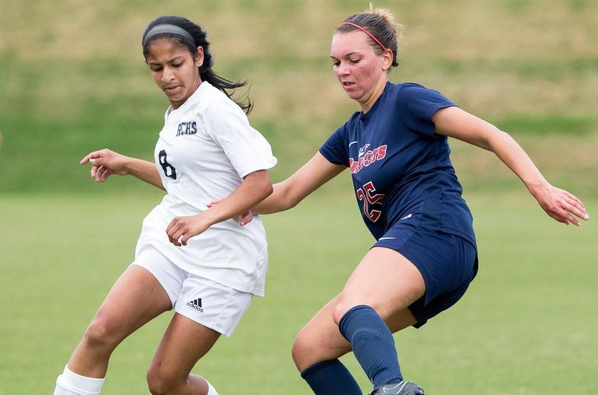 Raleigh Charter's Ashley John (8) and Franklin Academy's Anna Krussow (25) fight for a ball during a high school soccer game in Cary, N.C. on Friday, Apr. 21, 2017.