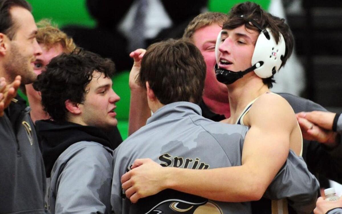 Holly Springs' celebrates Elijah Geniesse's win in the 160-pound weight class during the wrestling match, which took place on Thursday, January 21, 2016 in Cary. Holly Springs won 38-31.