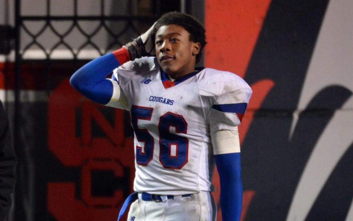 Wake Forest High School linebacker Darius Hodge (56) watches a video replay as Mallard Creek scores their final touchdown as they beat the Cougars 59-21during the NCHSAA 4AA championship at Carter Finley Stadium in Raleigh, N.C. Saturday Dec. 14, 2013.