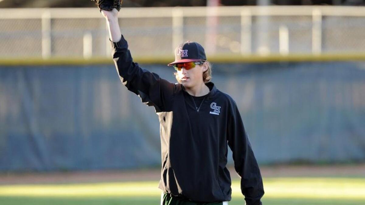 Green Hope's injured Jordan Montgomery warms up the outfielders during the Bobby Murray Tournament game against Wakefield, which took place in Raleigh on Saturday, April 2, 2016. Green Hope won 11-1.