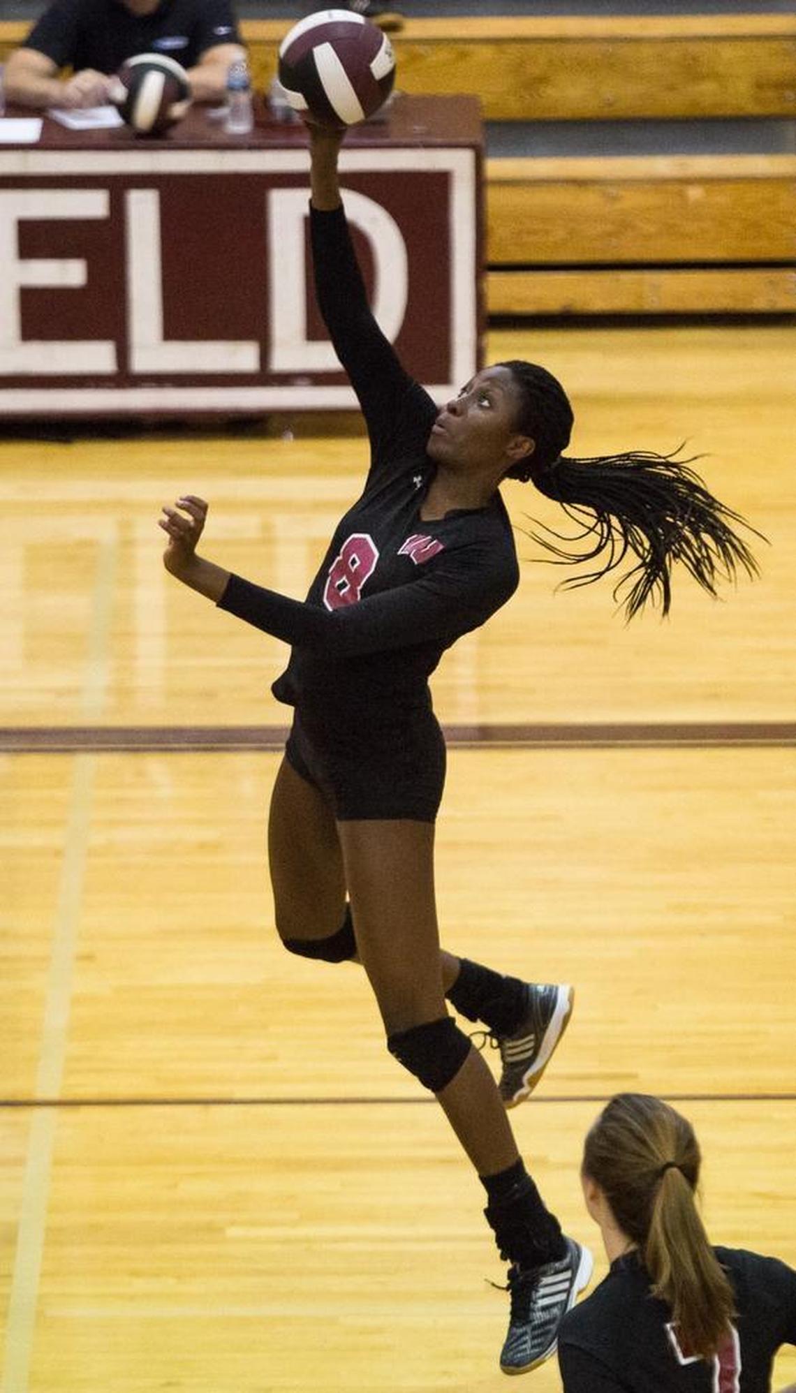 Wakefield's Ade' Owokoniran (8) spikes the ball during a high school volleyball game against East Chapel Hill in Raleigh, N.C. on Wednesday, Oct. 26, 2016.
