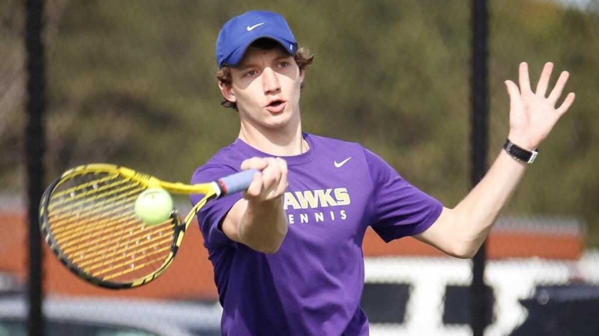 Holly Springs' Grant Miller returns a shot in his doubles match with teammate Siddharth Vasisht during Holly Springs' tennis match against Apex on Tuesday, April 5, 2016.