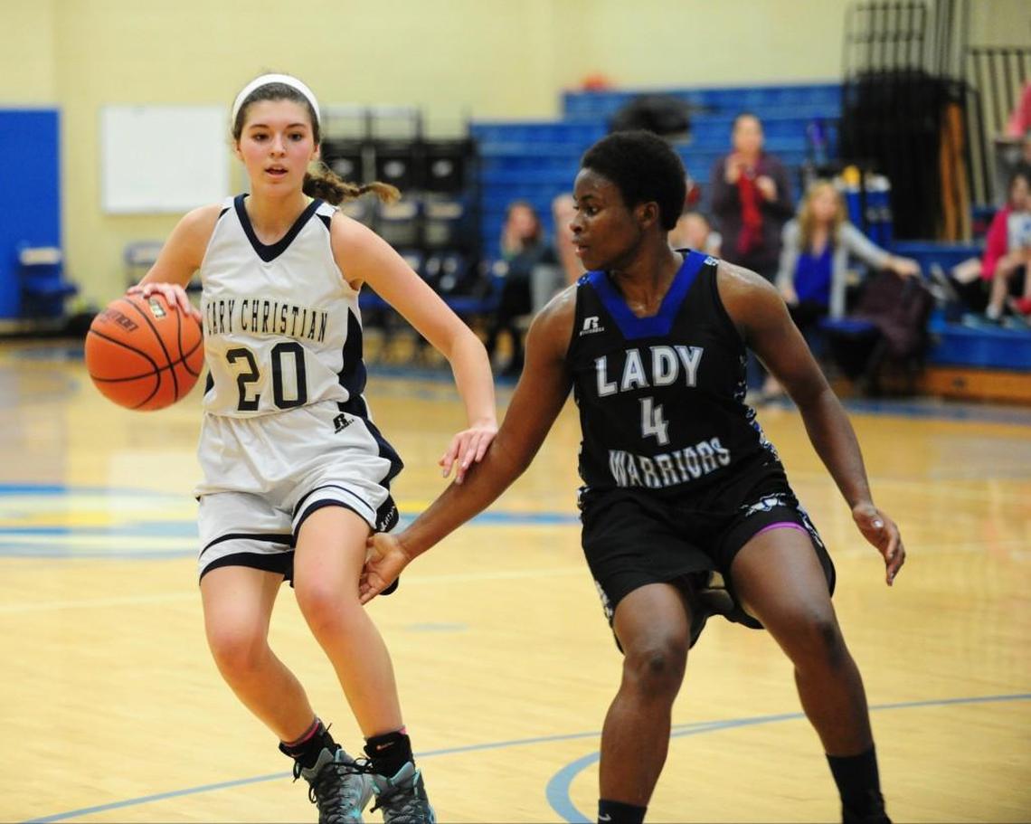 Fayetteville Christian’s Onyeka Monyei (4) guards Cary Christian's Grace Smith (20) during the girls basketball game on Tuesday, December 29, 2015 in Cary. Fayetteville Christian won 71-64 in overtime.
