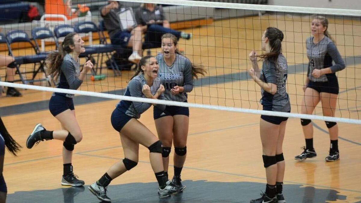 Ariana Rosario, second from left, of Millbrook celebrates after scoring a point along her teammates. The Millbrook Wildcats played the Heritage Huskies in a volleyball match that took place in Raleigh, N.C. on Thursday, September 1, 2016. Millbrook won 3-1.