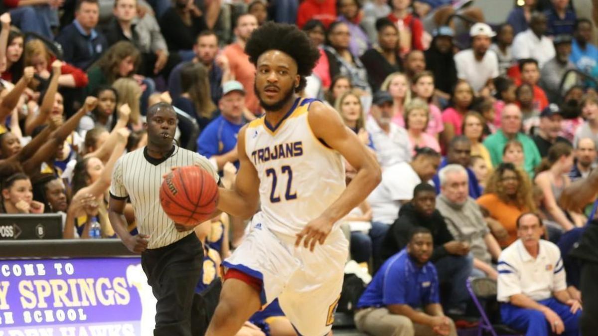 Garner's Kenyon Burt (22) looks to pass. The Garner Trojans and Holly Springs Golden Hawks boys played in the SWAC Conference basketball tournament championships on Feb.16, 2018.