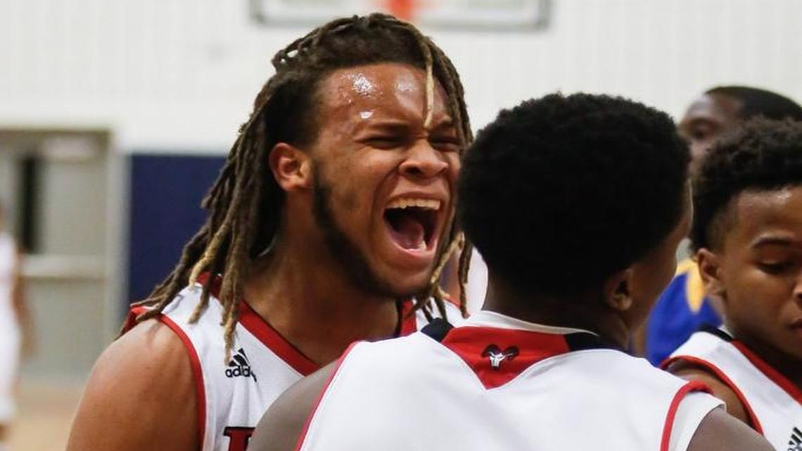 Rolesville's Elisha Bennett, left, celebrates a layup by teammate Israel Lockamy (3) late in East Wake's boys basketball game at Rolesville on Friday, December 16, 2016. Rolesville won the game 56-32.