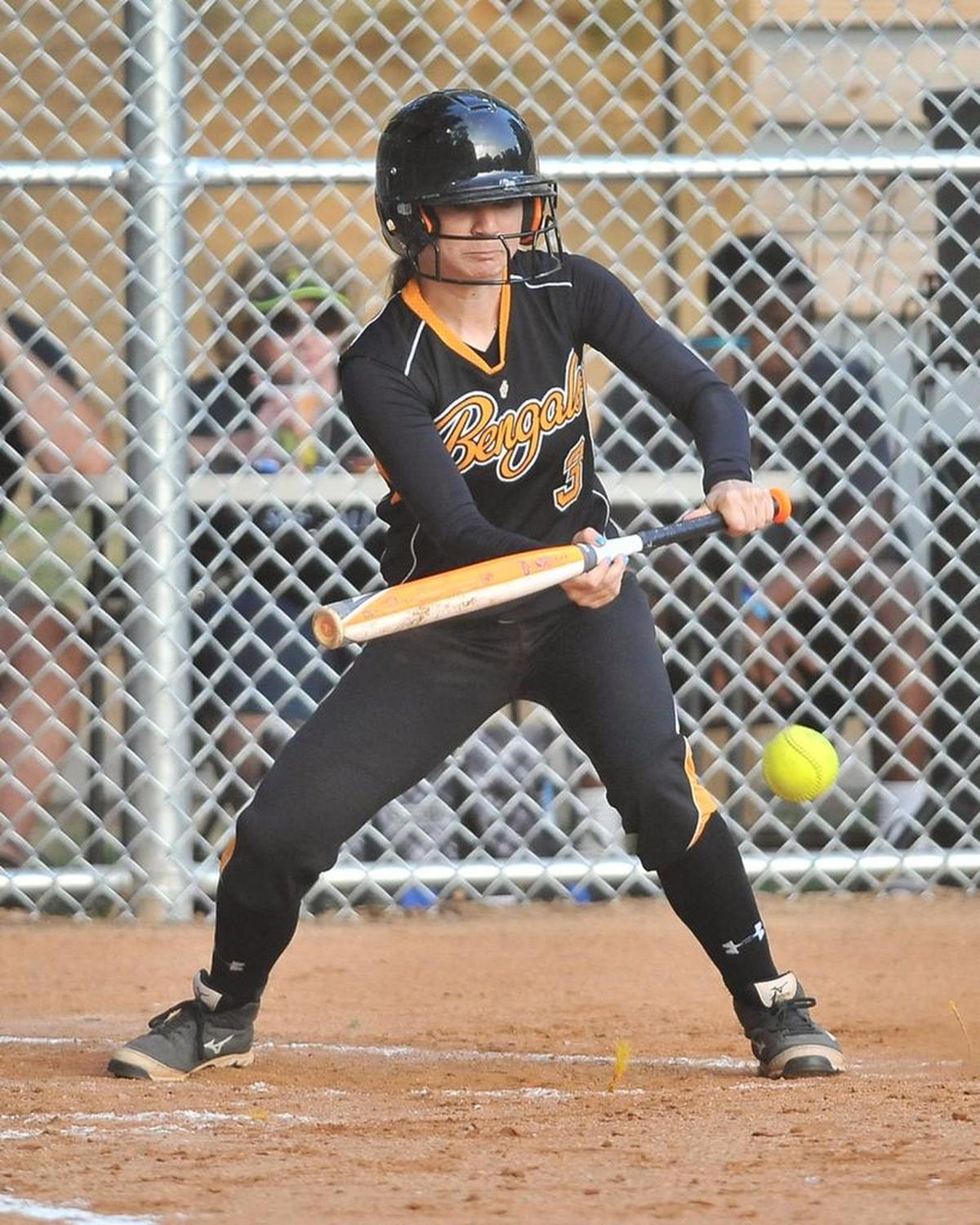 Fuquay-Varina's Taylor Smith (3) bunts the ball. Wake Forest took on Fuquay-Varina in an NCHSAA 4a playoff softball game in Wake Forest, N.C. on May 15, 2015. Fuquay-Varina won 7-5.