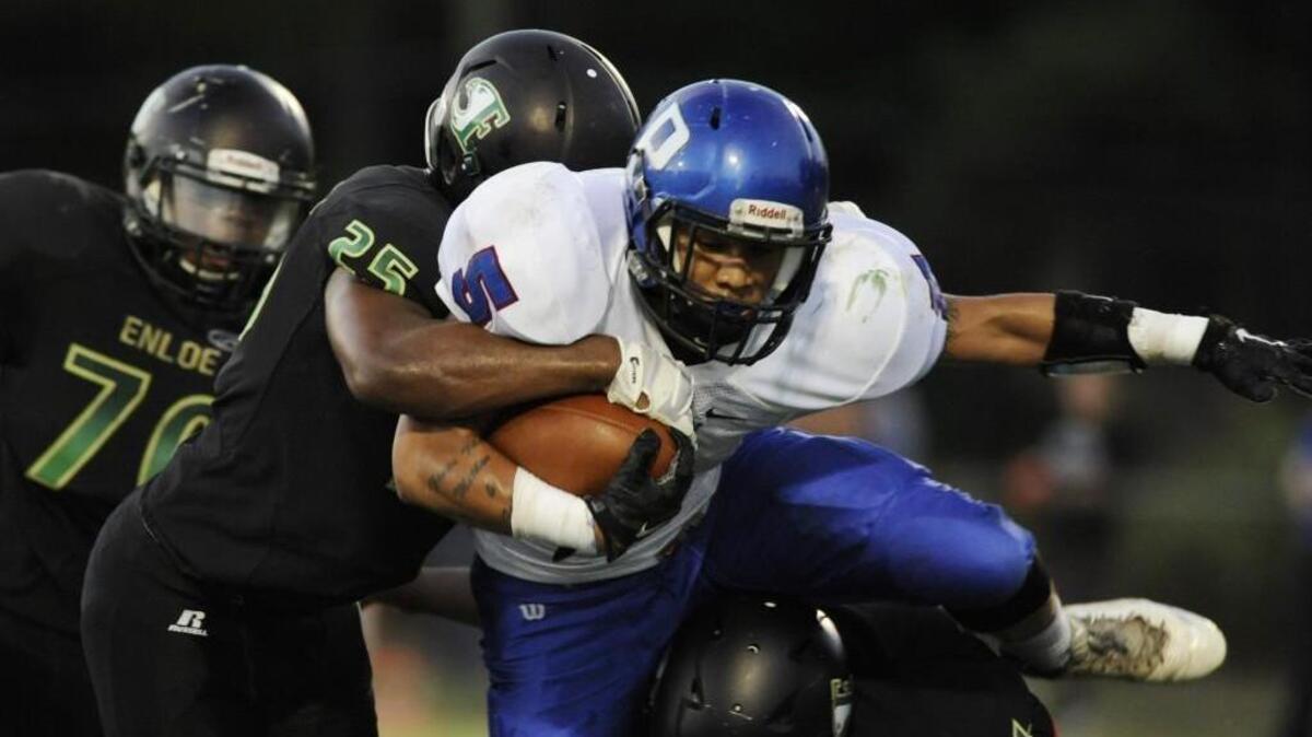 Enloe's Javon Johnson (25) tackles Person's Fredrick Harris (5) in Raleigh, N.C. on Friday, September 16, 2016.