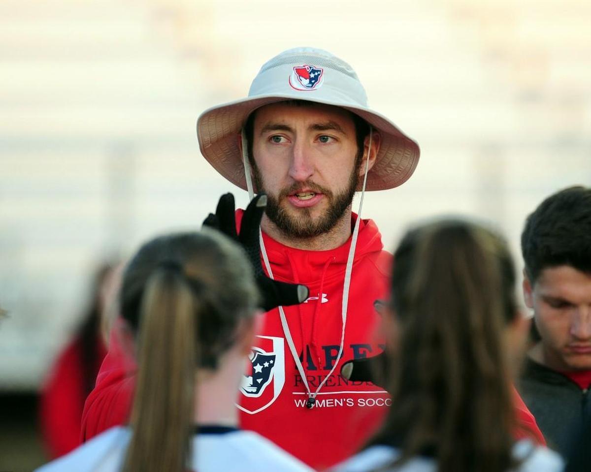 Apex Friendship coach Derek Blackwelder talks to his team during the girls soccer game against Middle Creek, which was played in Apex on Thursday, March 23, 2017. Middle Creek won 5-0.