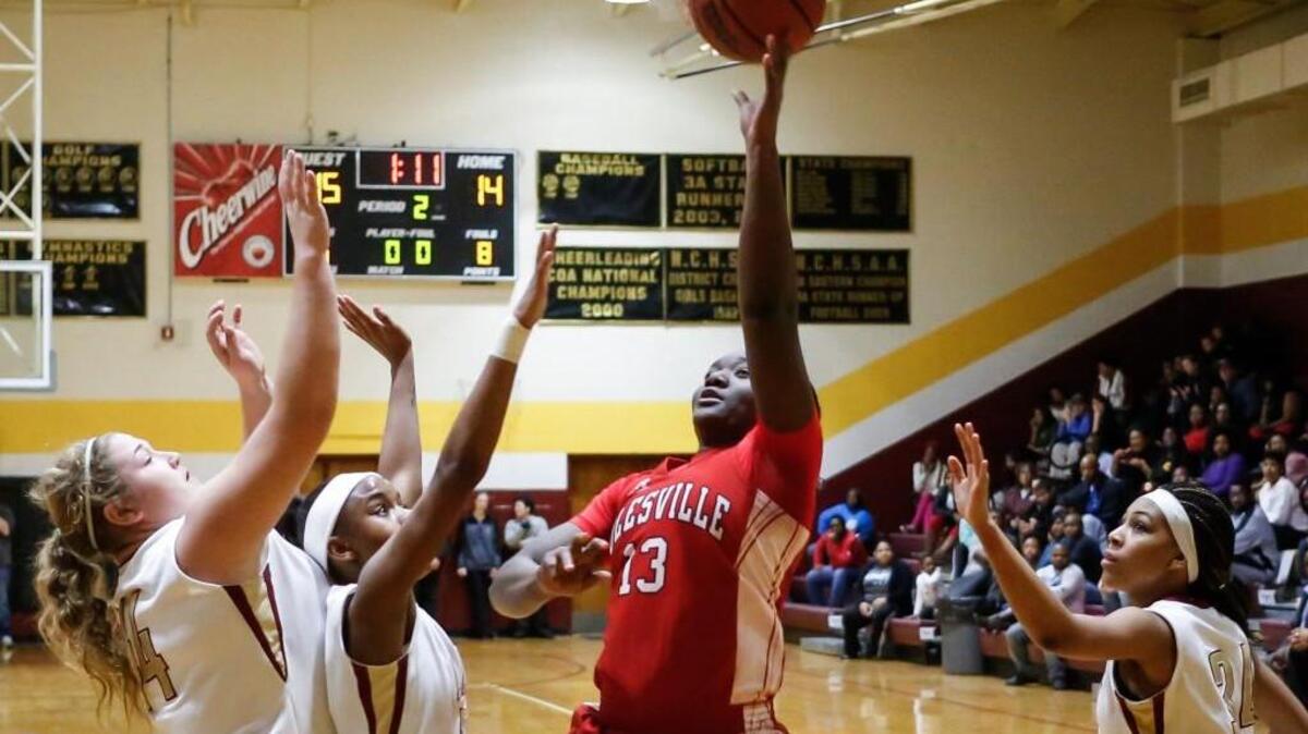 Rolesville's Jaylin Powell (13) puts up a shot over Harnett Central defenders during the Rolesville girls' basketball game at Harnett Central on Friday, February 5, 2016. Rolesville won 42-34.