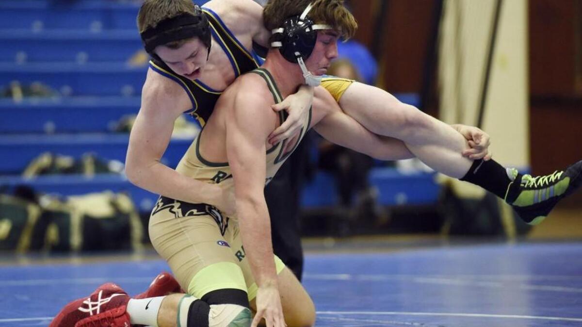 Cary Academy's Jacob Henderson and Ravenscroft's Ian Conley compete in the 152 pound weight class at the TISAC wrestling championships in Cary, N.C. on Thursday, February 11, 2016. Conley won the match in the championship round.