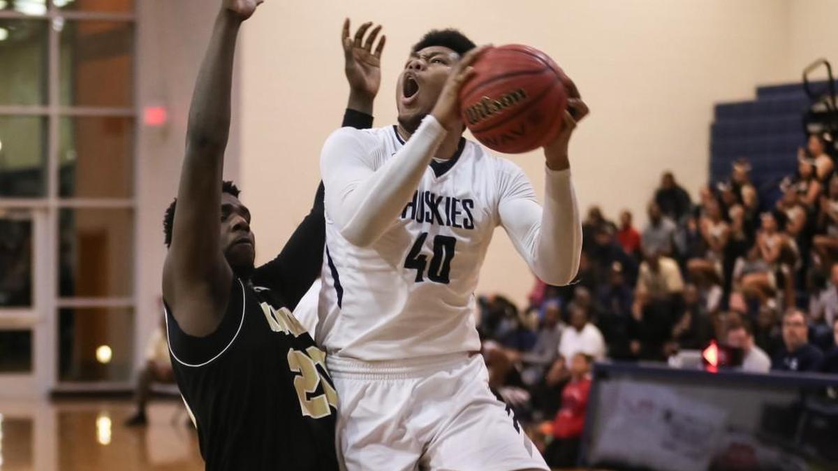 Heritage's Jayden Gardner (40) goes up for a shot as Knightdale's Shayne Saigo (20) defends. The Heritage Huskies and Wakefield Wolverines girls and Heritage Huskies and Knightdale Knights boys played in the NAC6 4A Conference basketball tournament championships on Feb. 16, 2018.