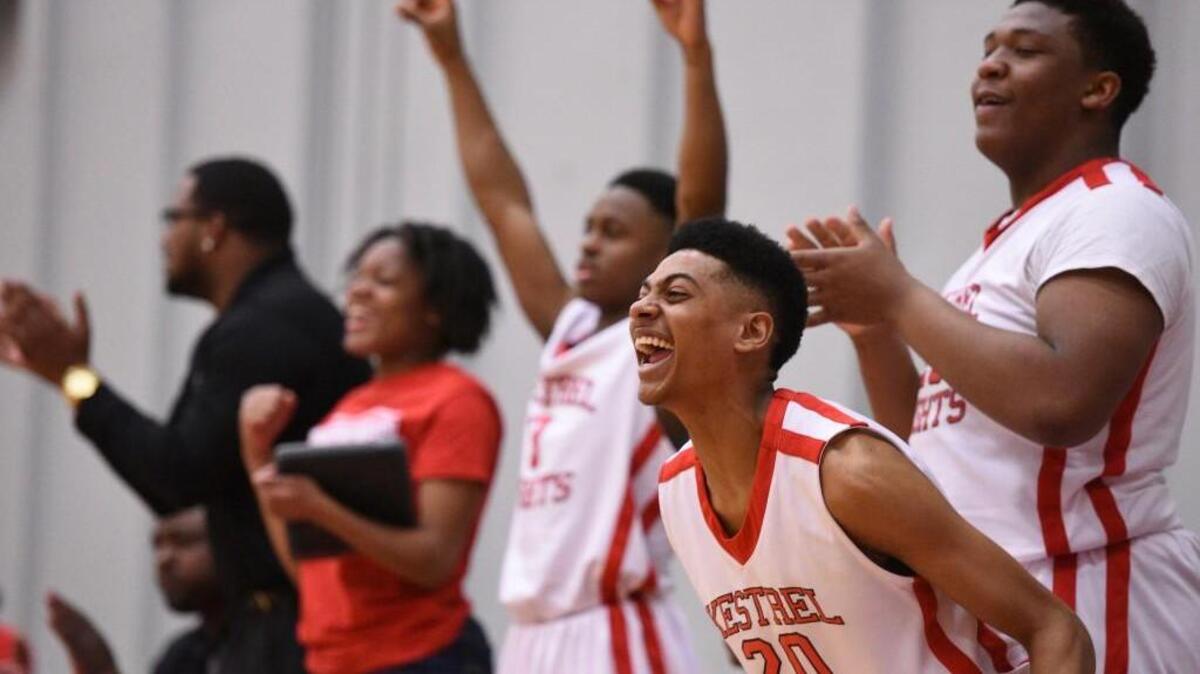 Kestrel's Barry Archer (20) and teammates cheer from the bench as Kestrel mounted a second half comeback to defeat East Carteret in the third round of the state playoffs at Kestrel Heights on Saturday, February 25, 2017. Special to The Herald-Sun | John Joyner