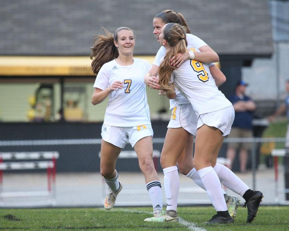 Apex's Emma Totten ( 9) scores and get congratulated by Sophie Coleman (middle) and Maddy Mangenero ( 7) during the Apex Friendship Patriots high school soccer game with the Apex Cougars high school on April 17, 2017. Apex won the game 3-0.