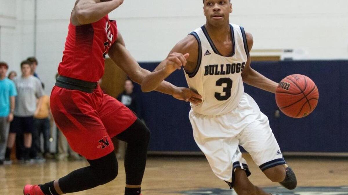 Wake Christian Academy’s Rob Whitfield (3) handles the ball as Neuse Christian’s Maurice Wilcox, left, defends during a high school basketball game in Raleigh, N.C. on Thursday, Feb. 4, 2016. Neuse Christian defeated Wake Christian 103-83.