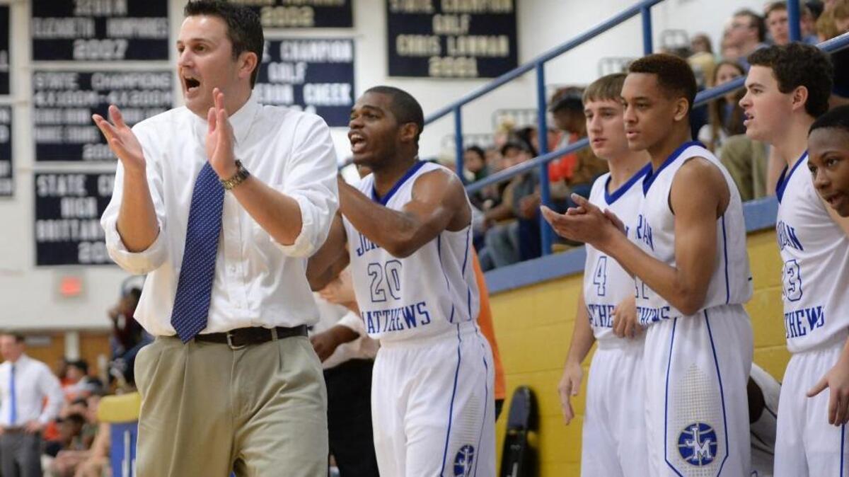 P.J. Lowman, left, head coach of Jordan-Matthews encourages his players from the sideline. The Jordan-Matthews Jets played the Northwood Chargers in a boys basketball game that took place in Siler City, N.C. on Saturday, January 16, 2016. Jordan-Matthews won 69-48.