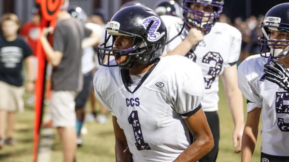 Community Christian's Dominque Evans (1) celebrates a long run by a teammate during Community Christian's football game at Cary Christian on Friday, September 9, 2016. Community Christian won the game 54-24.