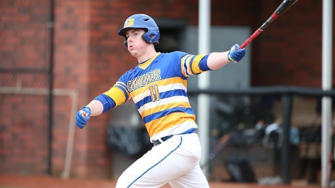 Garner's Nolan McLean (11) gets a hit. The Holly Springs Golden Hawks and the Garner Trojans played Baseball and Softball Ball in Holly Springs on March 27, 2018.