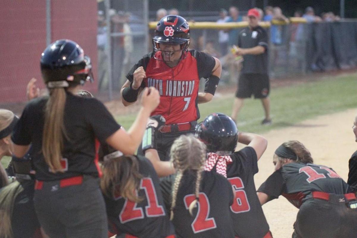 North Johnston's Jada Santiago (7) is congratulated by teammates at the plate after hitting a three run homer to tie the game during the Bunn High School softball game against North Johnston High School in Kenly, N.C. on Tuesday, May 16, 2017.