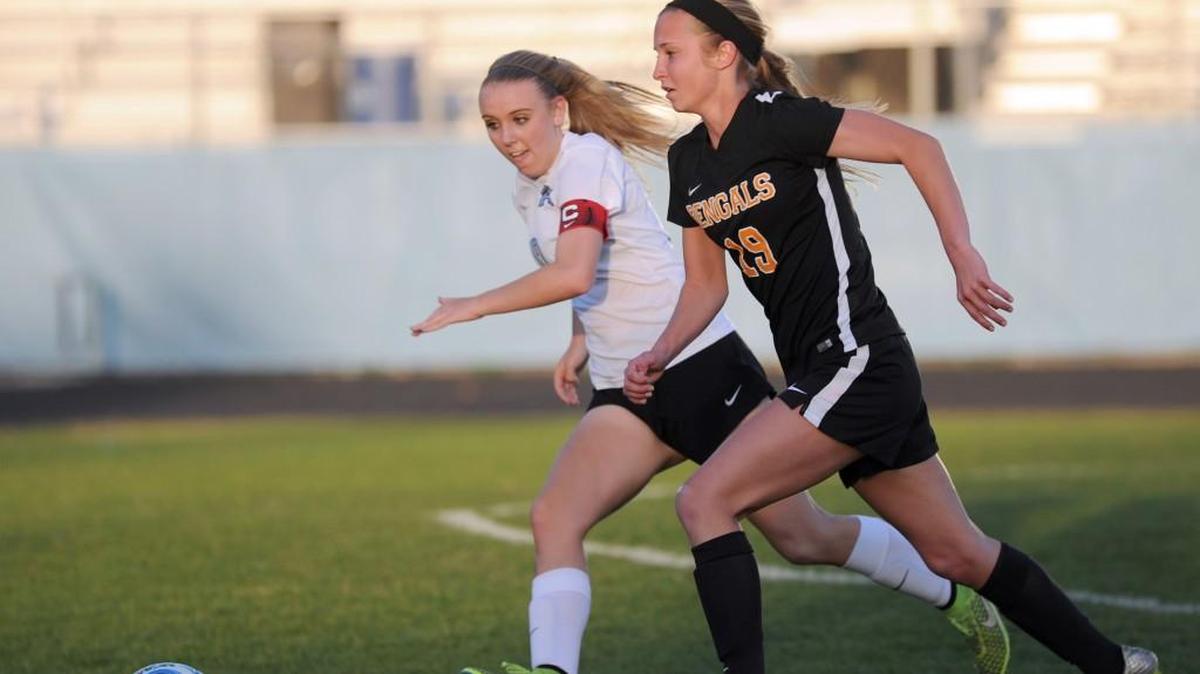 Fuquay-Varina's Megan Greene (right) chases a loose ball during the girls soccer game, which was played in Cary on Wednesday, March 23, 2016. Fuquay-Varina won 3-1.